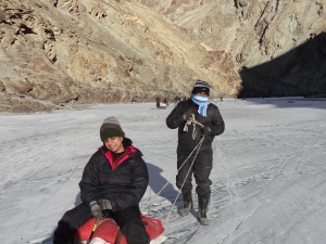 Vinay and Kanthi Playing on the sledge. You see our porters getting our bag to our camp site.